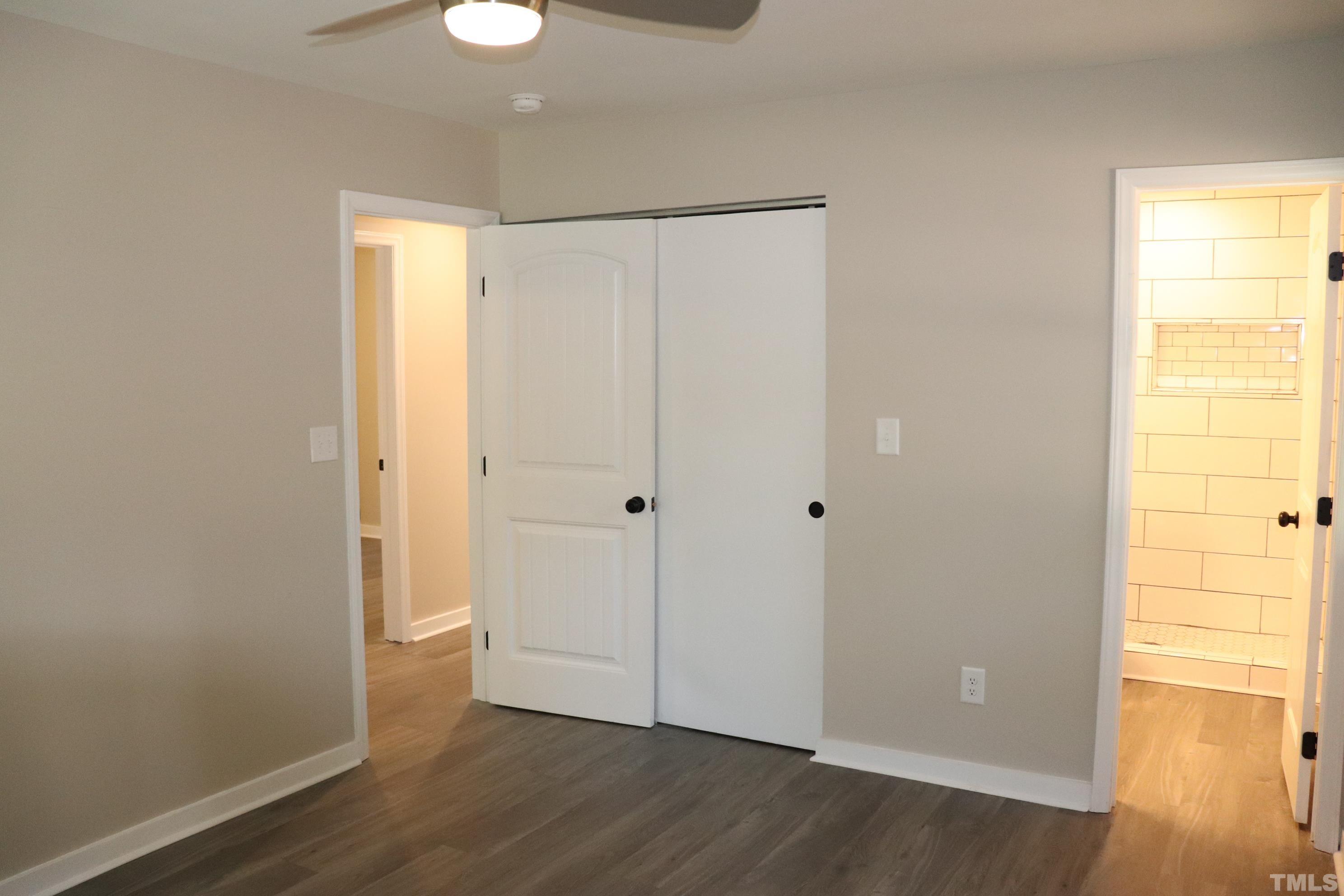 1108 Wyldewood Road Durham, NC 27704 - Photo 28 of 35 a view of an empty room with wooden floor and a window
