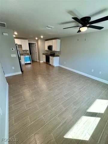 a view of kitchen with a sink and a refrigerator