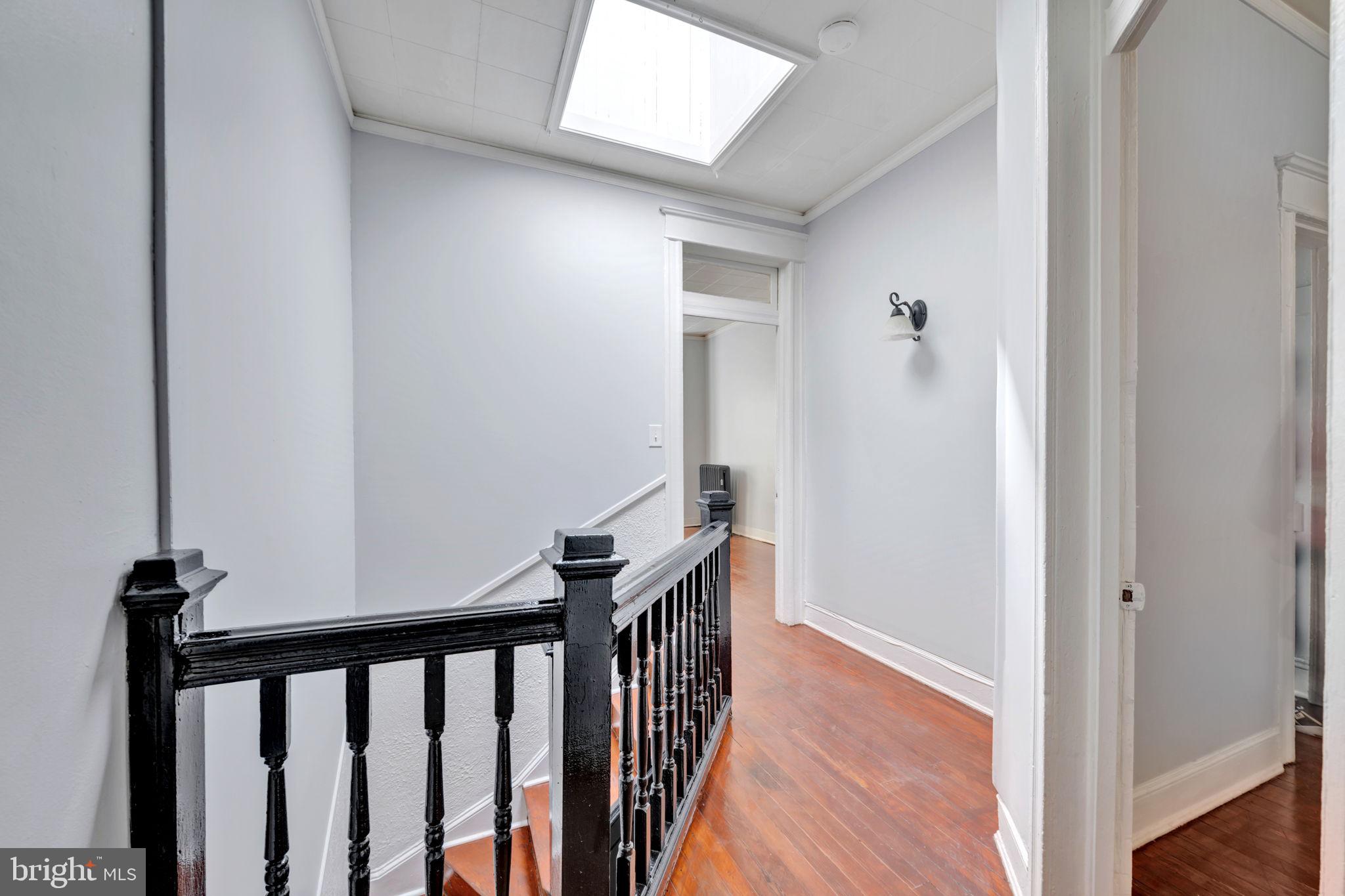 2822 Riggs Avenue Baltimore, MD 21216 - Photo 21 of 30 a view of a hallway with wooden floor