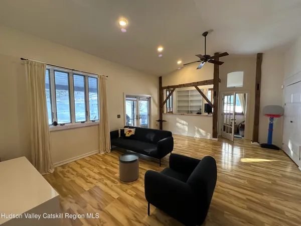 a living room with furniture and wooden floor