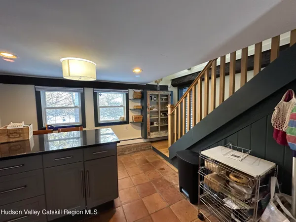 a living room with furniture a window and flat screen tv