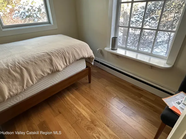 a large bed sitting in a bedroom next to a window