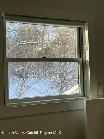 a backyard of a house with lots of trees