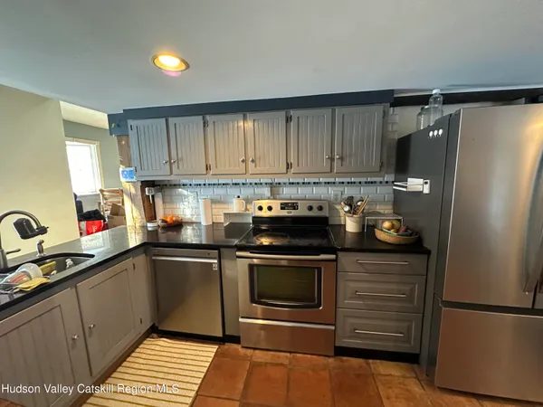 a kitchen with a sink stainless steel appliances and cabinets