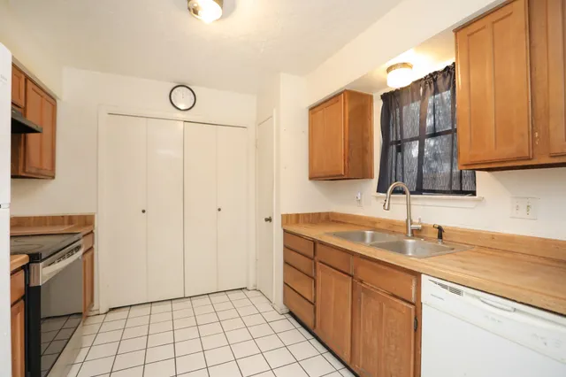 a kitchen with a sink cabinets and appliances