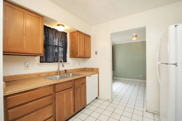 a kitchen with a sink window and cabinets