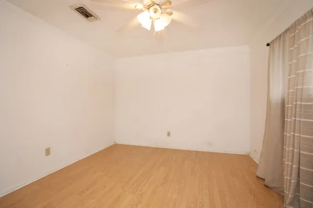 a view of a small space with a wooden floor and a window