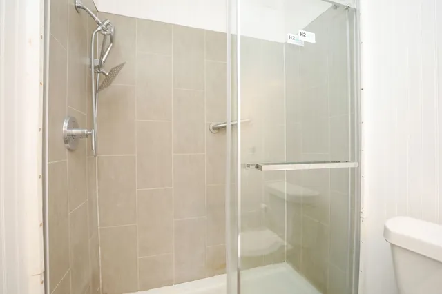 a bathroom with a glass shower door