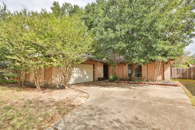 a wooden house with trees in front of it