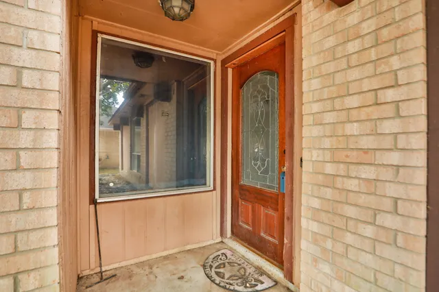 a view of a door and a window