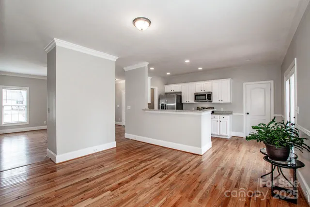 a view of kitchen with wooden floor and electronic appliances