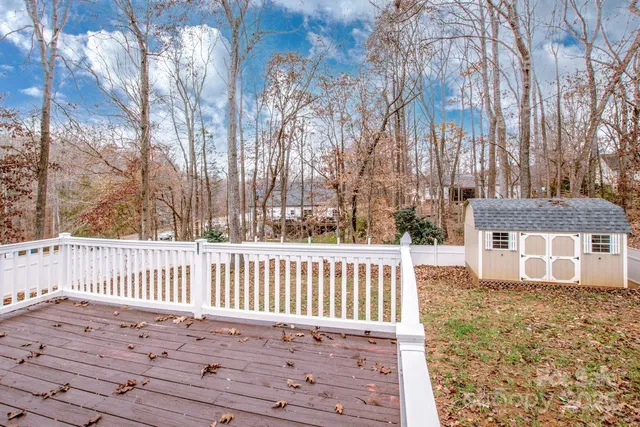 a view of a house with wooden fence