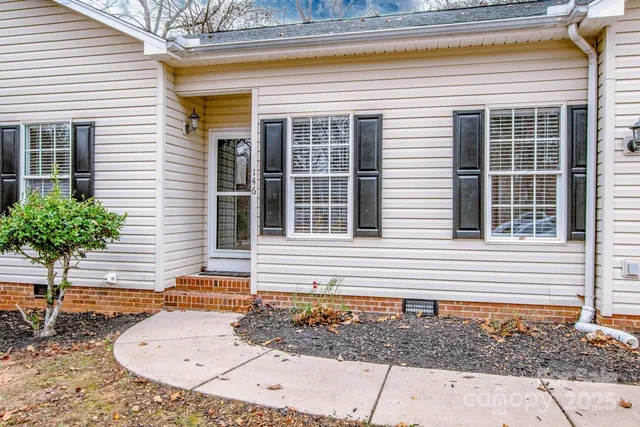 a view of a house with a small deck