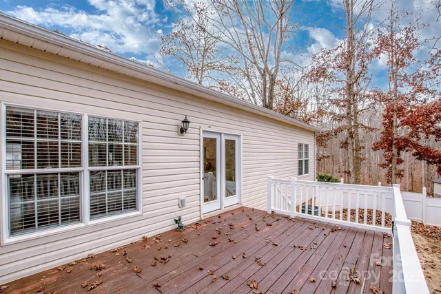 a view of a house with a wooden bench
