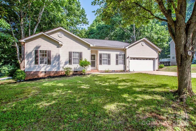 a front view of house with yard and green space