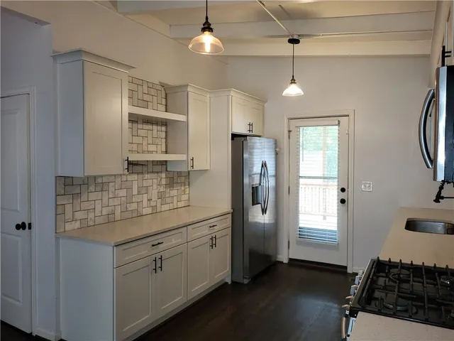 a kitchen with refrigerator and window