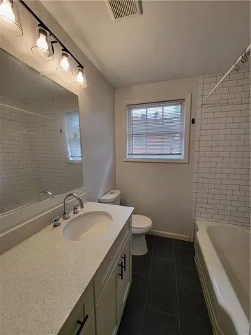 a bathroom with a sink a toilet and bathtub