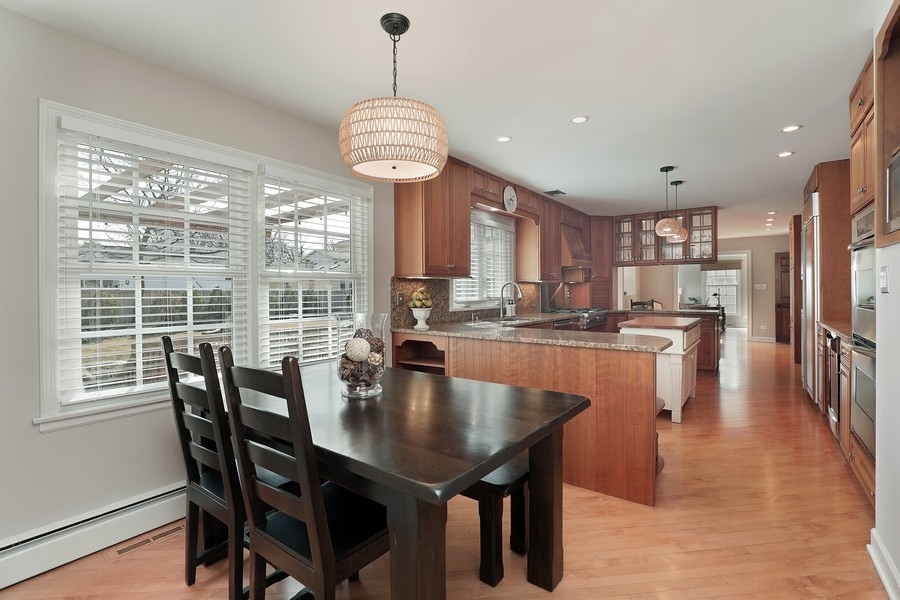 2915 Shannon Road Northbrook, IL 60062 - Photo 9 of 33 a dining room with stainless steel appliances granite countertop a table chairs and a chandelier