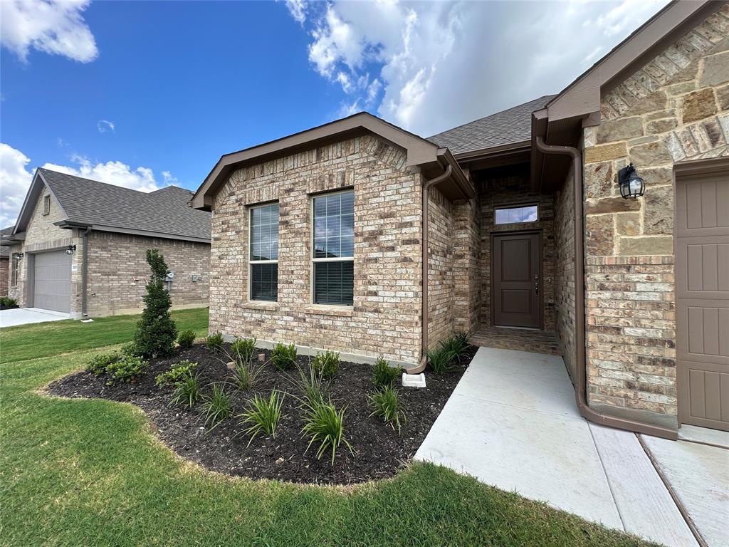 5231 Meadow Lane Krum, TX 76249 - Photo 2 of 17 Brick and stone veneer exterior with dark brown trim and gutters