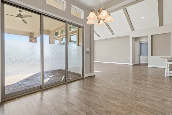 a view of a room with wooden floors and window