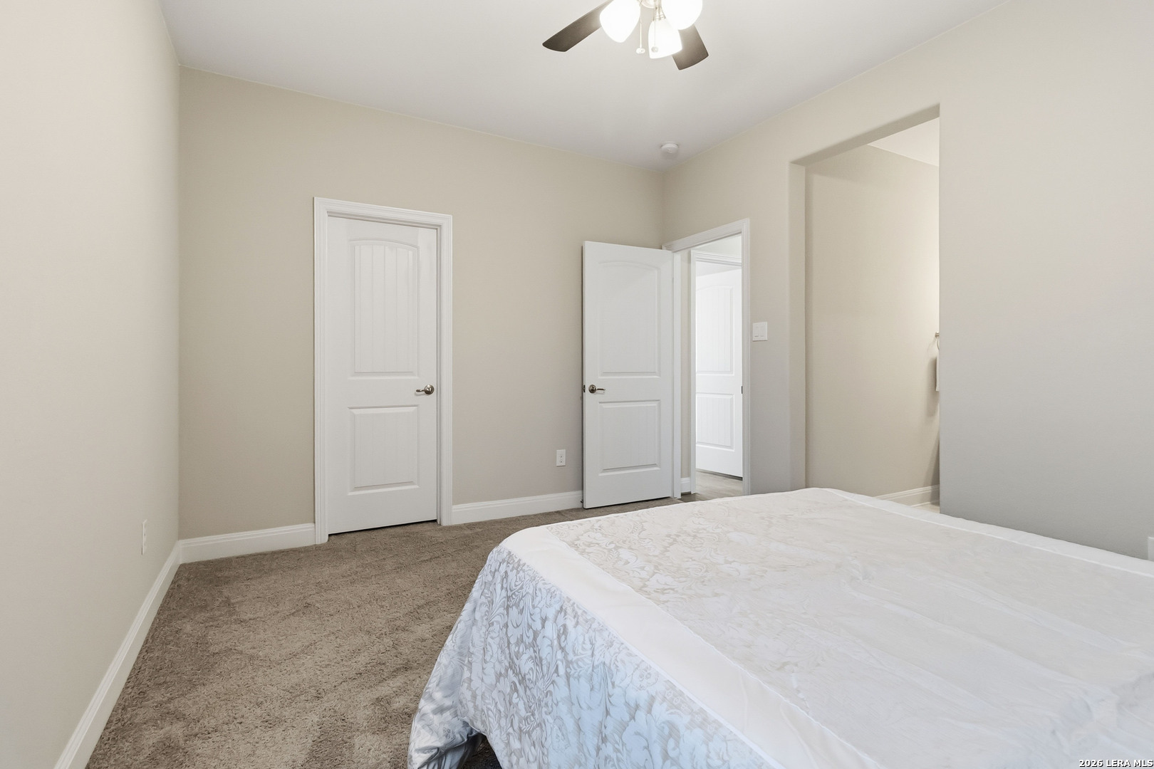 3337 Harvest View Marion, TX 78124 - Photo 30 of 39 a spacious bedroom with a bed and a chandelier