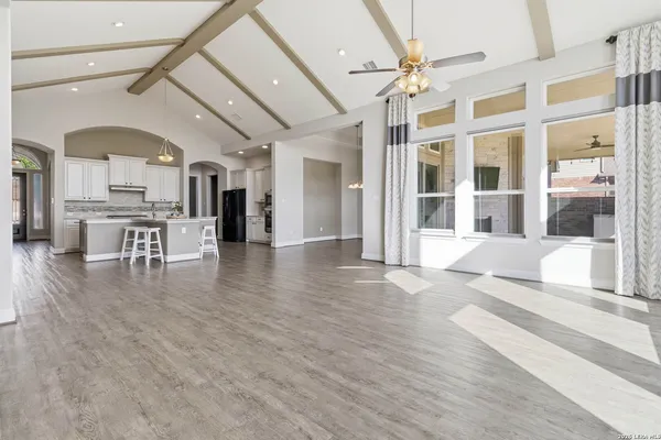 a view of a room with wooden floor and large windows