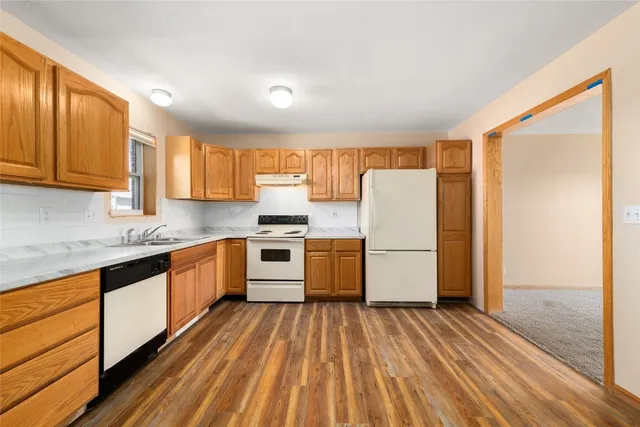 a kitchen with stainless steel appliances a refrigerator and wooden cabinets