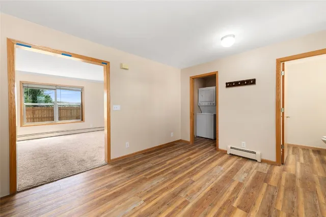 an empty room with wooden floor and a window