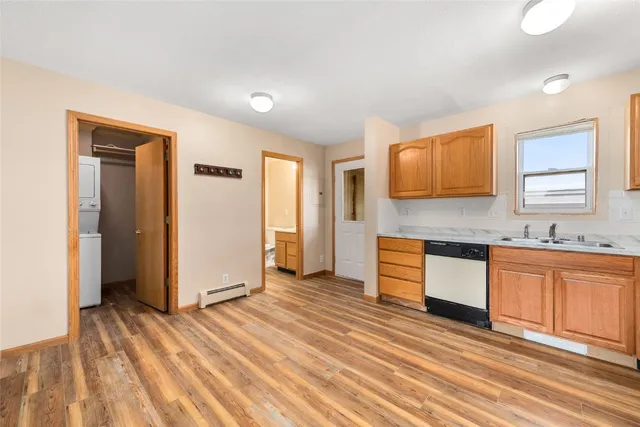 a view of a kitchen with wooden floor and a sink