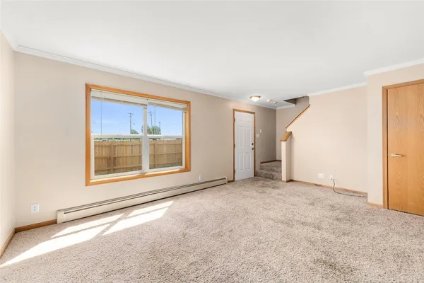 an empty room with a empty space and windows