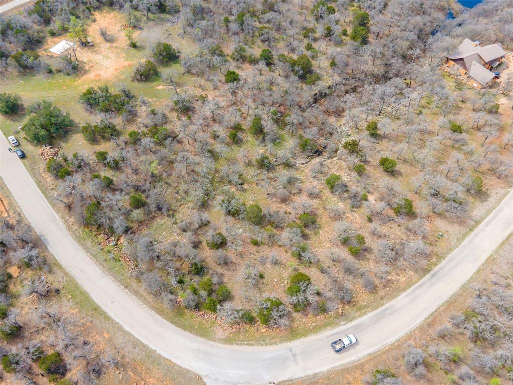 E49 R Art's Way Gordon, TX 76453 - Photo 5 of 26 Aerial view of 2.87-acre corner lot in The Ranches at Clayton Mountain, Gordon TX, showing flat building area, gully, and small stream