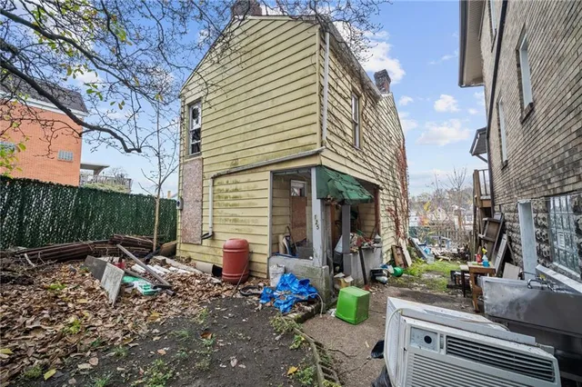 a view of house with outdoor space and sitting area