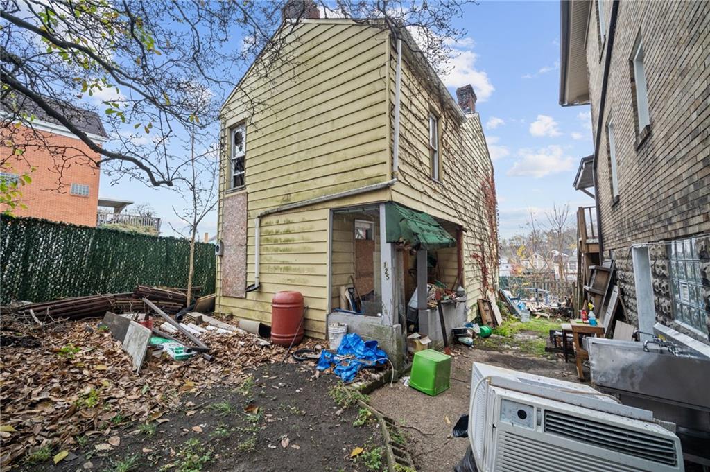 a view of house with outdoor space and sitting area