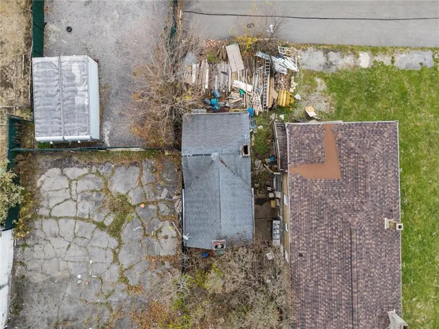front view of a stone house with a yard