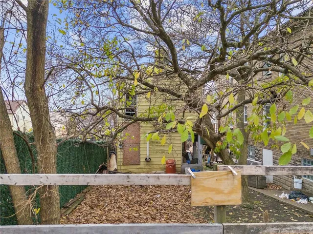 front view of a house with a tree