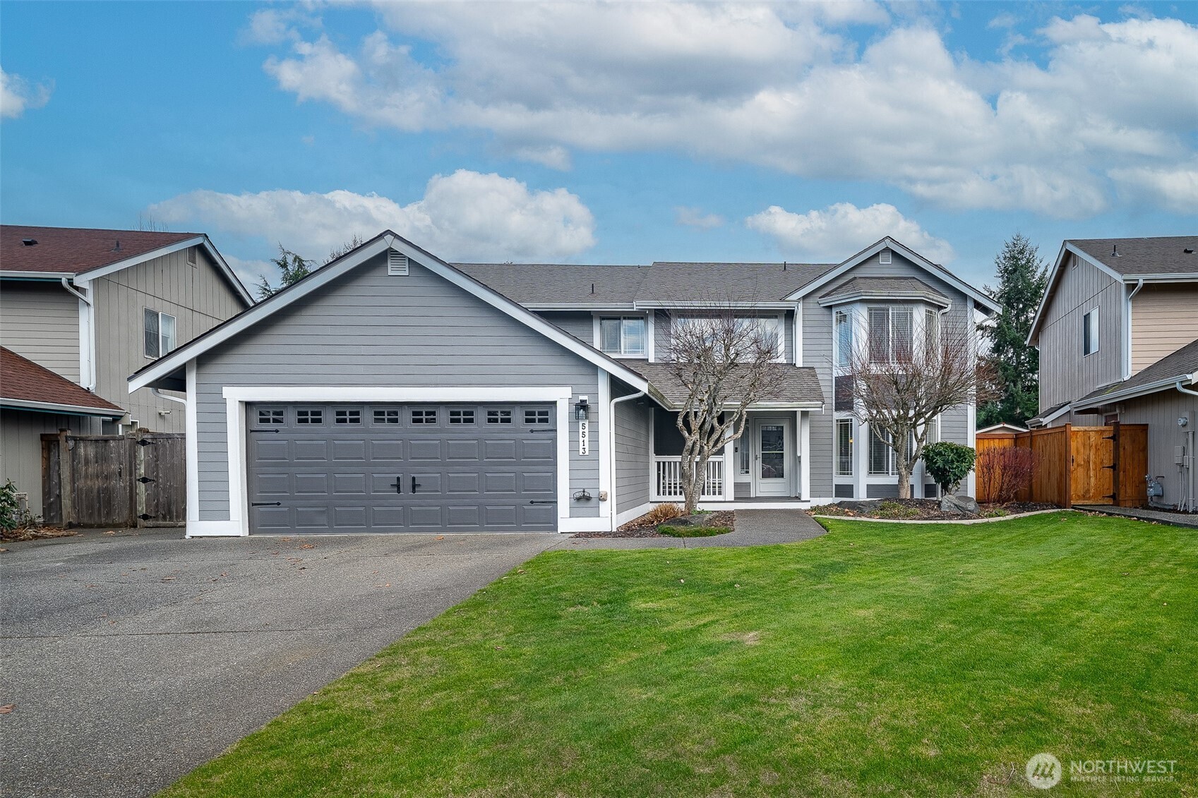 a front view of a house with a yard and garage