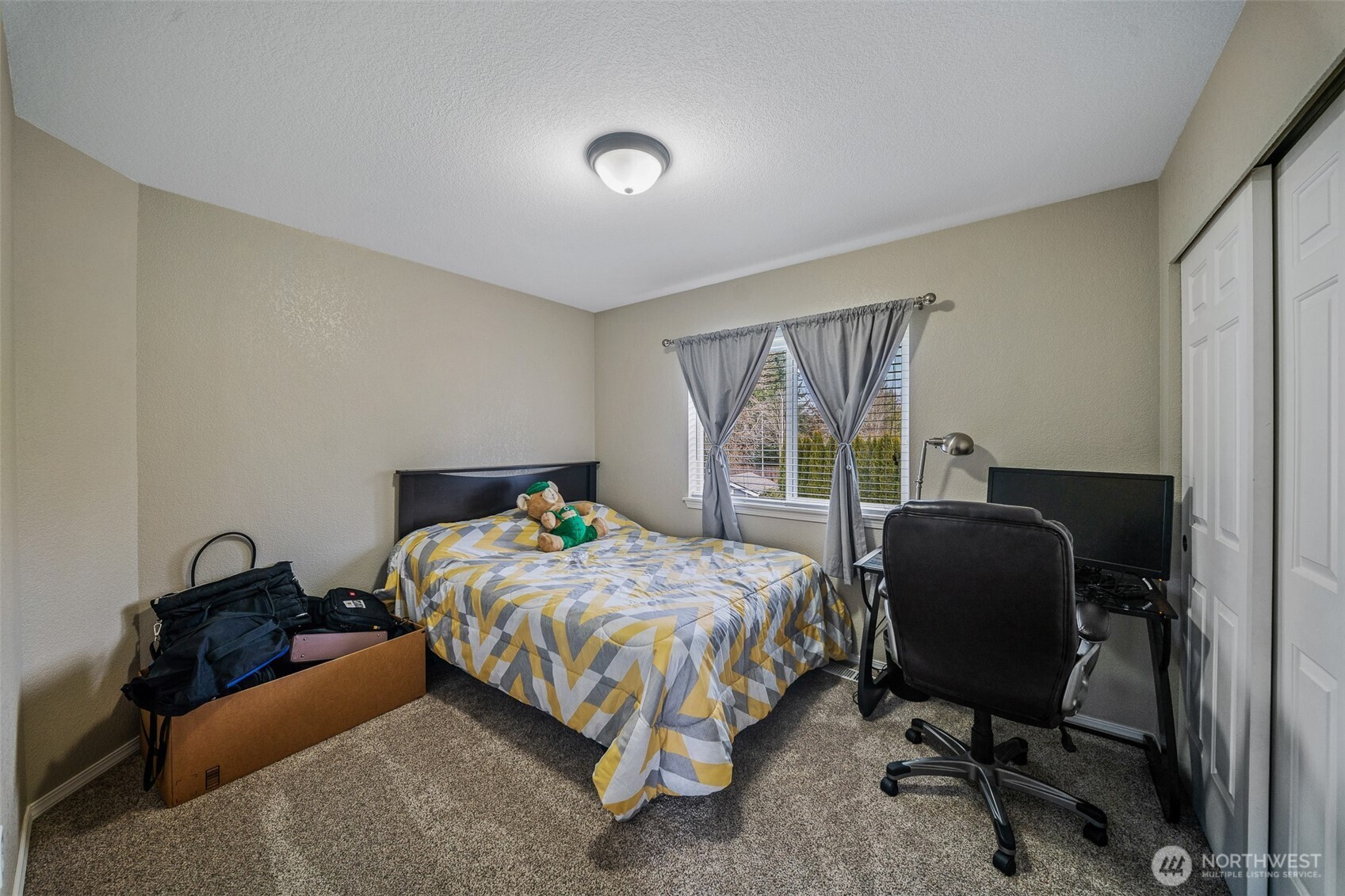 5513 Park Pl Loop Southeast Lacey, WA 98503 - Photo 16 of 33 a bedroom with a bed and a chair