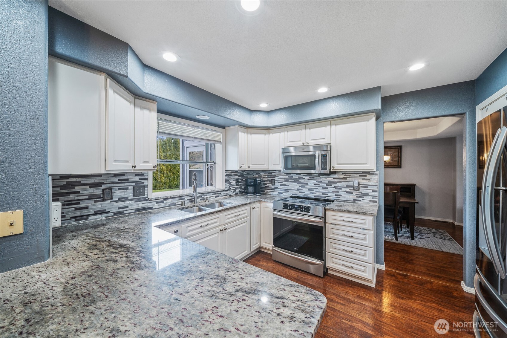 5513 Park Pl Loop Southeast Lacey, WA 98503 - Photo 7 of 33 a kitchen with stainless steel appliances granite countertop a stove a sink and a refrigerator
