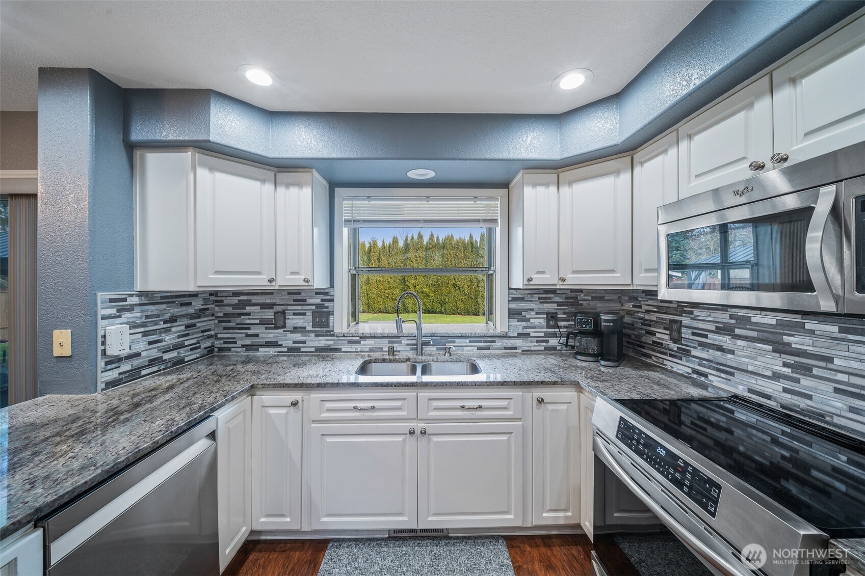 5513 Park Pl Loop Southeast Lacey, WA 98503 - Photo 8 of 33 a kitchen with stainless steel appliances granite countertop a sink stove and cabinets