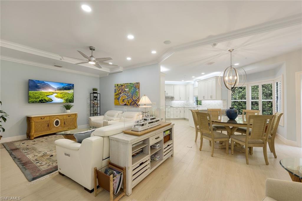 269 Colonade Circle, Unit 2802 Naples, FL 34103 - Photo 13 of 50 a living room with furniture and a flat screen tv