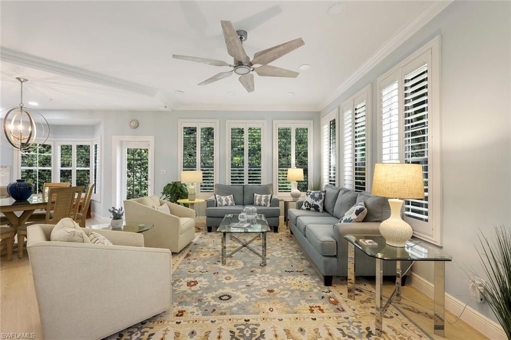 269 Colonade Circle, Unit 2802 Naples, FL 34103 - Photo 14 of 50 a living room with furniture large window and ceiling fan