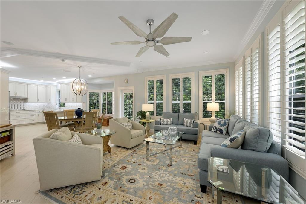 269 Colonade Circle, Unit 2802 Naples, FL 34103 - Photo 15 of 50 a living room with furniture and a large window