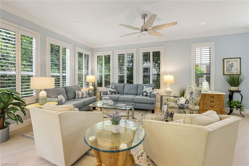 269 Colonade Circle, Unit 2802 Naples, FL 34103 - Photo 16 of 50 a living room with fireplace furniture and a large window