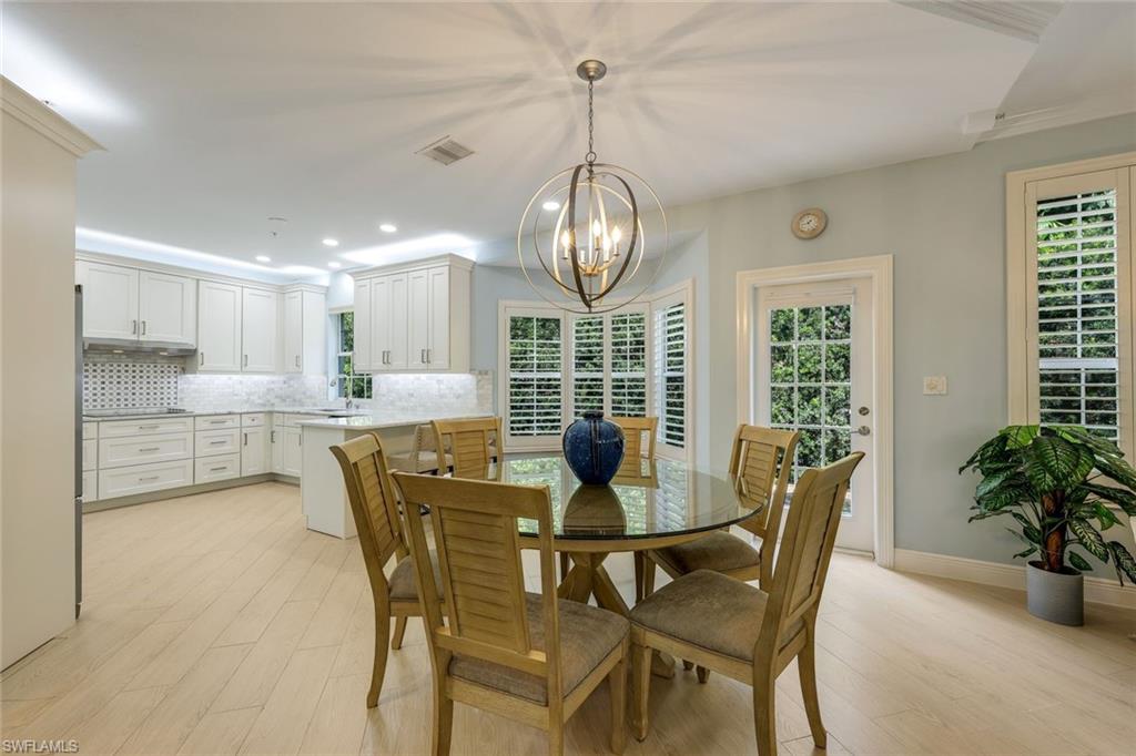 269 Colonade Circle, Unit 2802 Naples, FL 34103 - Photo 23 of 50 a view of a dining room with furniture window and wooden floor
