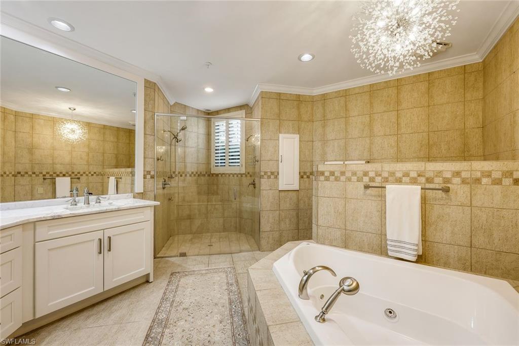 269 Colonade Circle, Unit 2802 Naples, FL 34103 - Photo 26 of 50 a bathroom with a tub sink and mirror