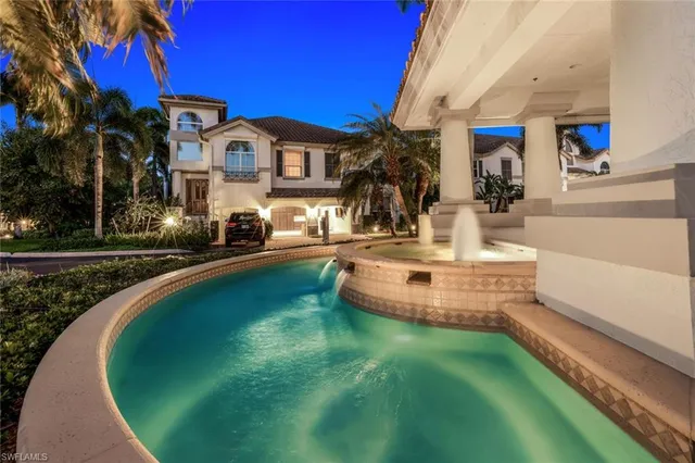a view of a house with swimming pool and sitting area