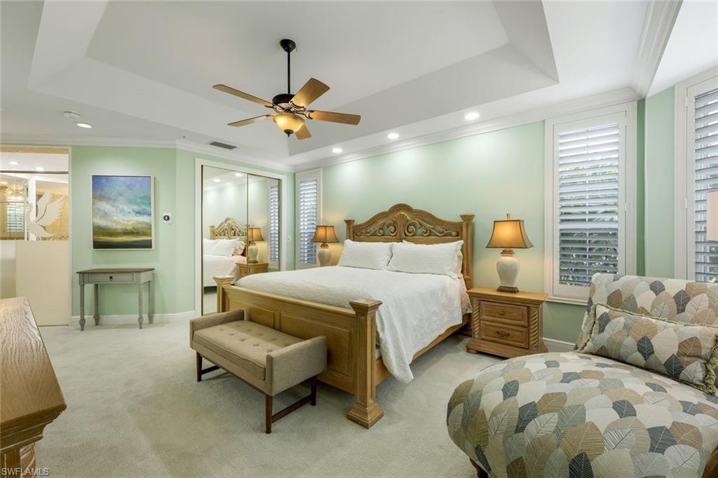 269 Colonade Circle, Unit 2802 Naples, FL 34103 - Photo 34 of 50 a bedroom with 2 bed and a chandelier