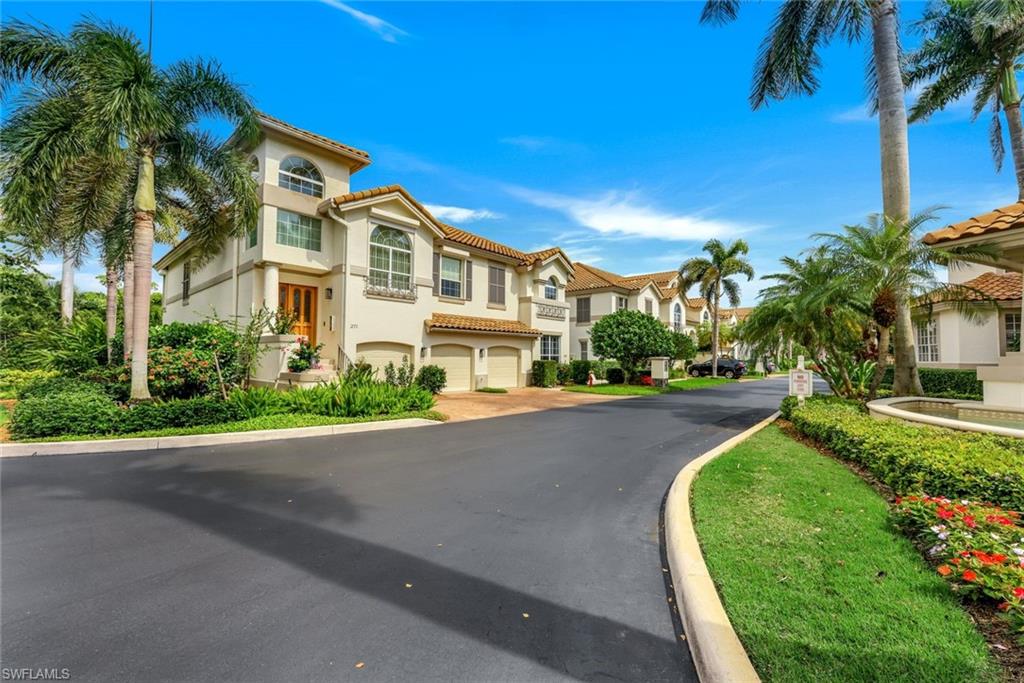 269 Colonade Circle, Unit 2802 Naples, FL 34103 - Photo 6 of 50 a front view of a house with a yard and potted plants