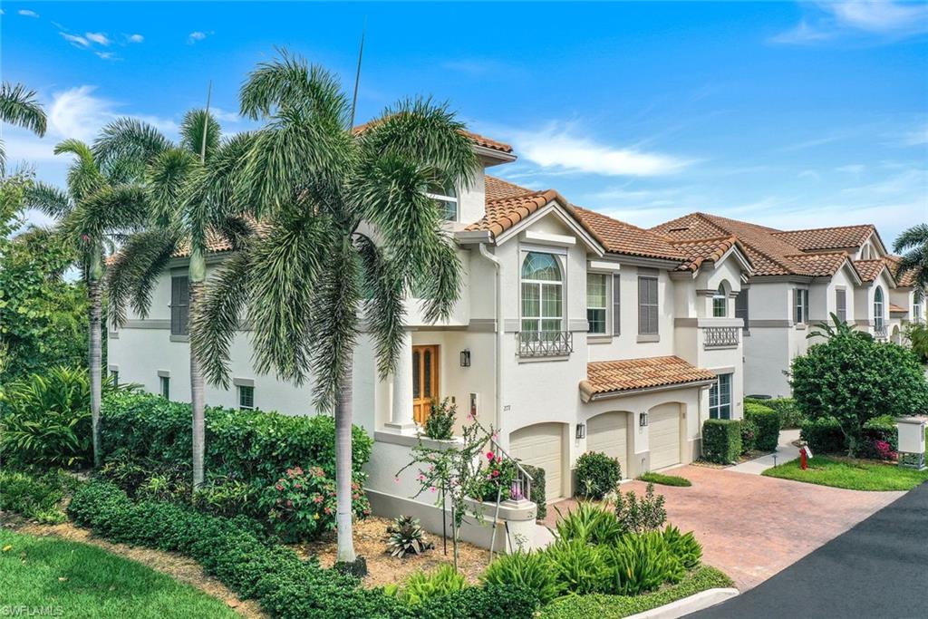 269 Colonade Circle, Unit 2802 Naples, FL 34103 - Photo 7 of 50 a front view of a house with a yard