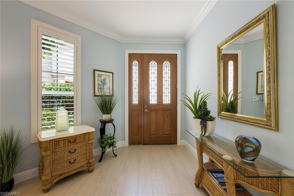 269 Colonade Circle, Unit 2802 Naples, FL 34103 - Photo 8 of 50 a room with window and flower pot